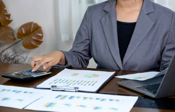 istock Businesswomen bookkeeper hand use calculator analysis the graph for Setting challenging business goals and ready to achieve target at home office 2174223371