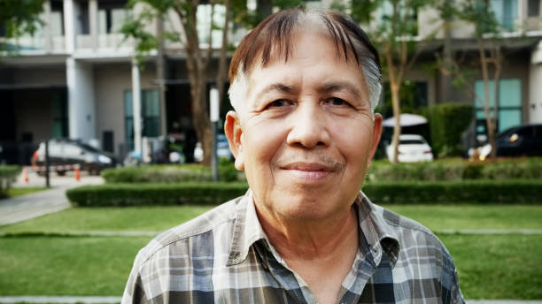 Portrait of a confident senior man standing outside and looking at camera