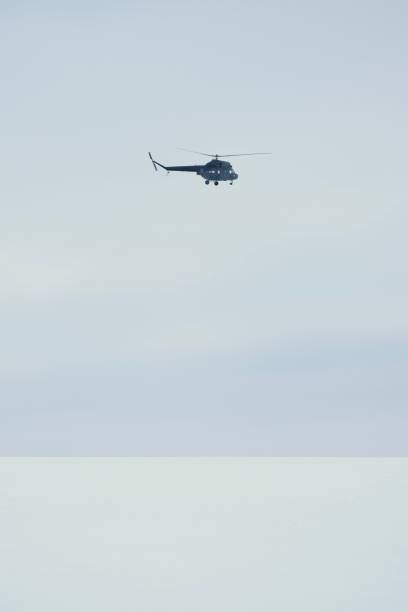 Helicopter above a white field of snow