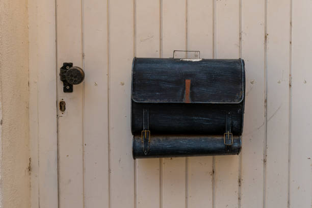 istock black metal briefcase is hanging on a white door 2174228270