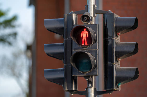 istock Red Pedestrian Traffic Light Near Brick Building on a Clear Day 2174228289