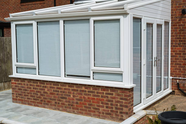 istock White lean to conservatory with blinds on all windows and doors, seen from the outside on a sunny day. 2174229119