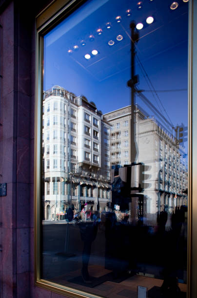 The vibrant reflection of elegant buildings shines in a shop window on Friedrichstrasse, capturing the essence of Berlin\