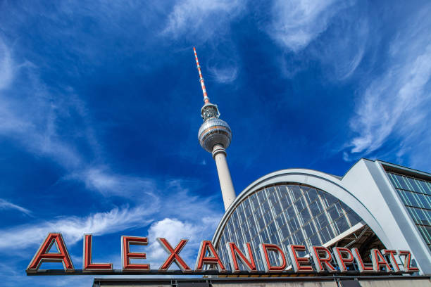 istock Alexanderplatz Station Sign With TV Tower Under a Bright Sky in Berlin 2174230878