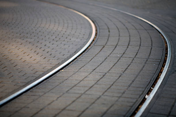 Tram tracks gently curve over a cobblestone surface in the heart of Alexanderplatz, showcasing Berlin\