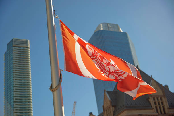 Toronto, Ontario, Canada- September 30th, 2022:flag lowered at half-mast at Toronto City Hall’s Nathan Phillips square for all the indigenous children that died at Resident schools in Canada. Today is National Day for Truth and Reconciliation.