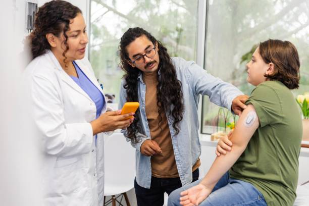 istock Hipster dad asks female doctor about preteen son's glucometer 2174234531