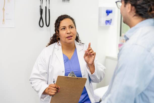 istock Female doctor gives unrecognizable man advice 2174234721