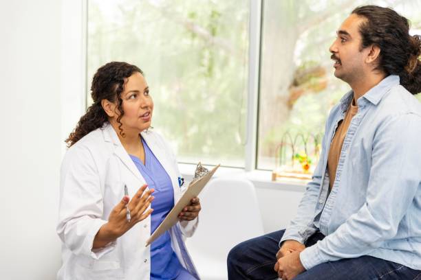 istock Female doctor asks specific questions about male patient's symptoms 2174234931