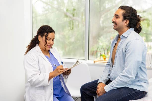 istock Female doctor documents male patient's symptoms 2174234936