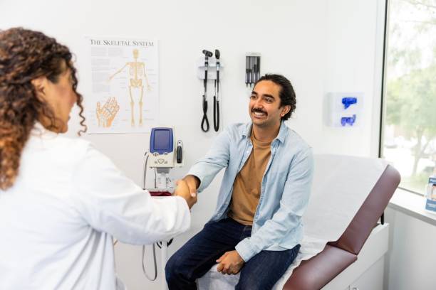 istock Entering exam room, female doctor greets man with handshake 2174234953