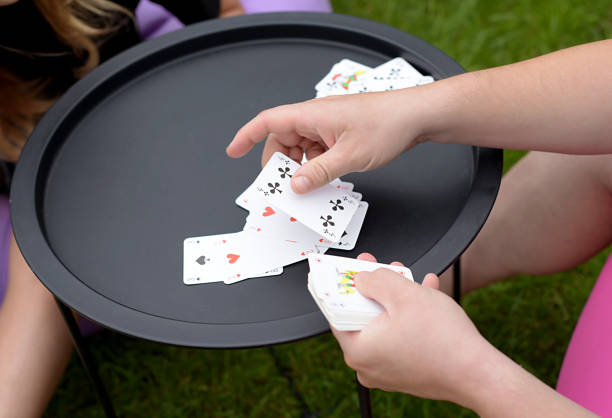 istock family playing cards outdoors. Board games 2174235539