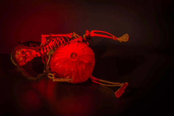 Scary skeleton in the web  for Halloween.Spooky Halloween wallpaper.Outdoor Halloween decor.