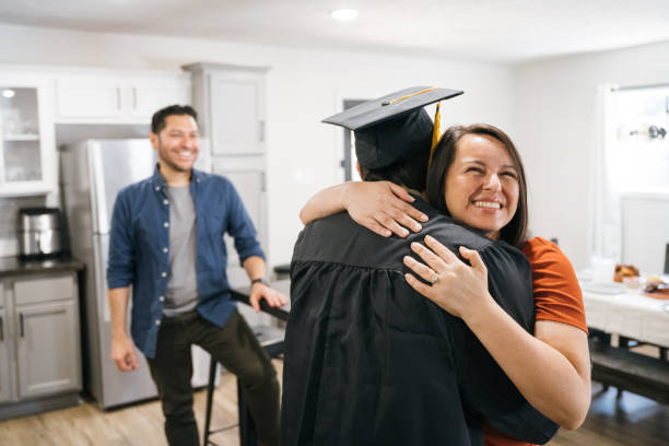 istock Proud mother embracing son on graduation day 2174242652