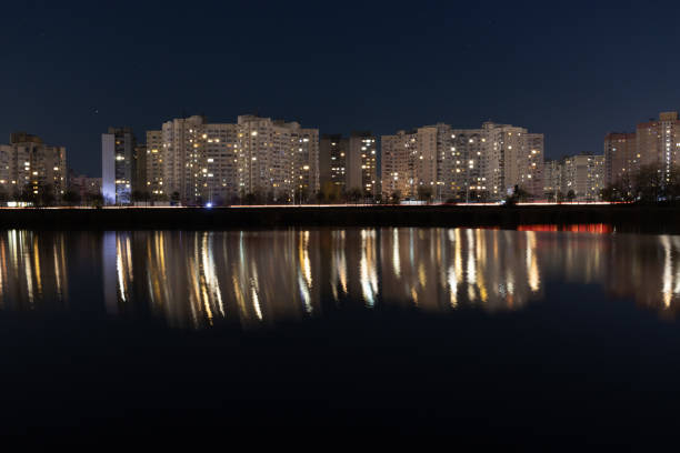Night Skyline with lights on the evening lake, Kyiv, Ukraine. Urban landscape