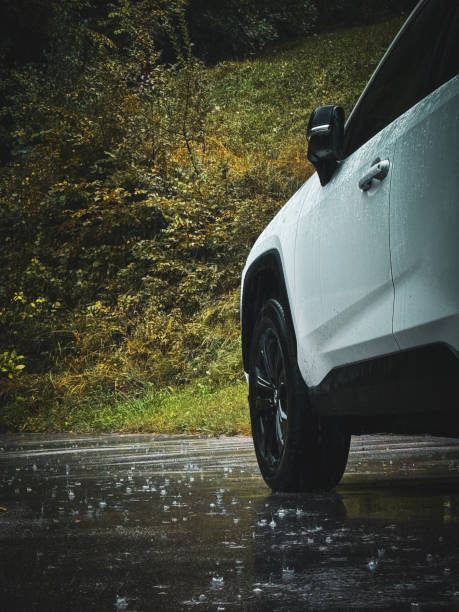 Wet car in the rain, front wheel close-up
