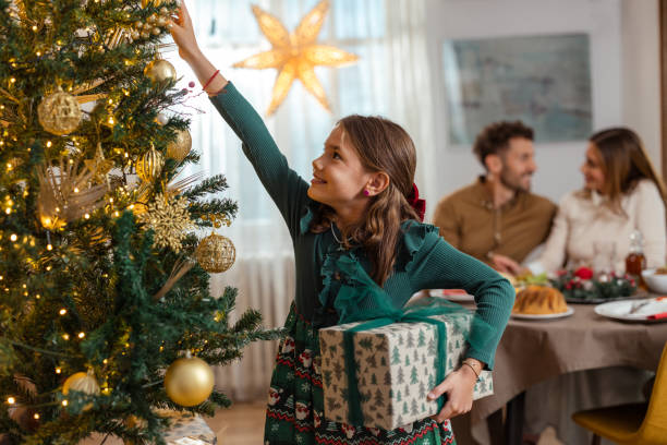 istock Cute girl decorating a Christmas tree 2174250796