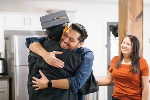 istock Proud father embracing son on graduation day 2174251815