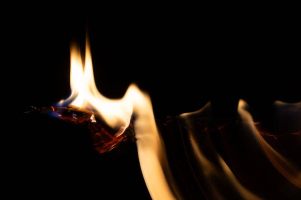 burning paper, glowing edge of paper on a black background