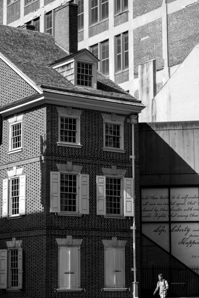 Philadelphia, USA - July 28, 2024. A man walking past historic building of Declaration House in Independence National Historic Park, Philadelphia, Pennsylvania, USA