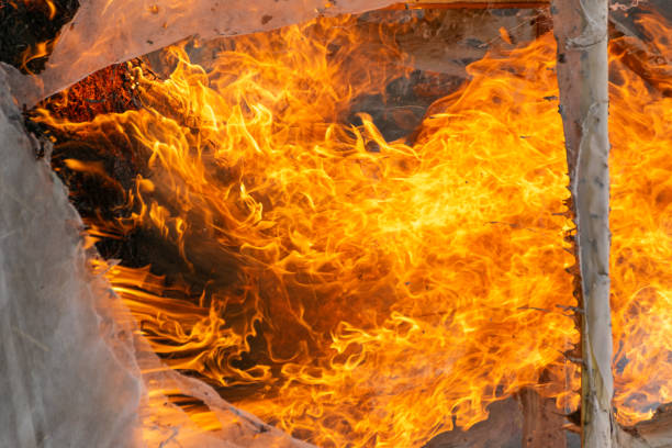 Abstract red fire natural texture, flames from a fire, a burning wooden structure. Burning orange hot sparks fly from large fire