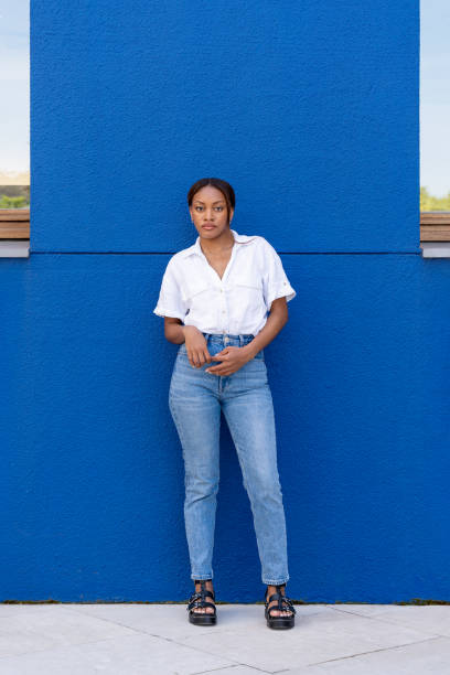 istock Young black woman posing with blue wall background in bilbao 2174259009