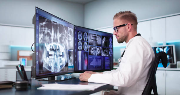 istock Dentist Doctor Looking At Teeth Xray 2174259018