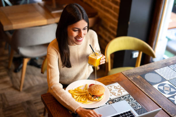 istock A young woman is taking a lunch break 2174259890