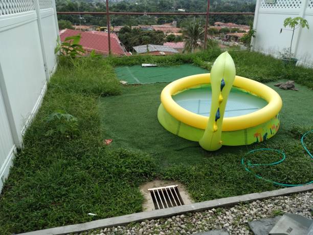 istock Home patio with grass and inflatable pool for children 2174261715