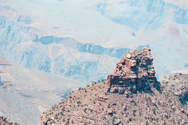 A detailed view of the Grand Canyon showcases its intricate layers of multicolored rock. The rich hues of red, orange, and brown create a mesmerizing texture, capturing the immense scale and geological beauty of this natural wonder.
