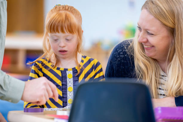 istock Parents playfully interact with their joyful young daughter, who has Down syndrome, coloring and enjoying themselves. 2174277873