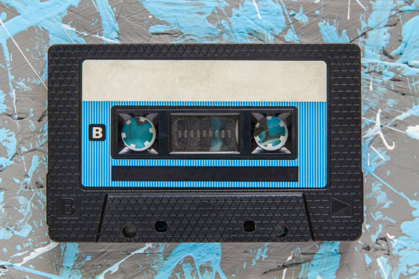 istock An old, dusty audiotape in a black plastic case sits against a blue-gray background 2174278275