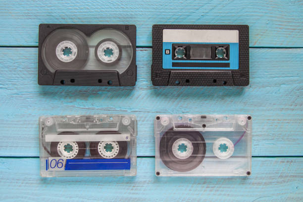 istock On a blue wooden background, there are four audio cassettes 2174278340