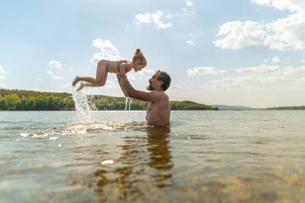 istock Father Lifting Child In Sunny Danube River. 2174278751