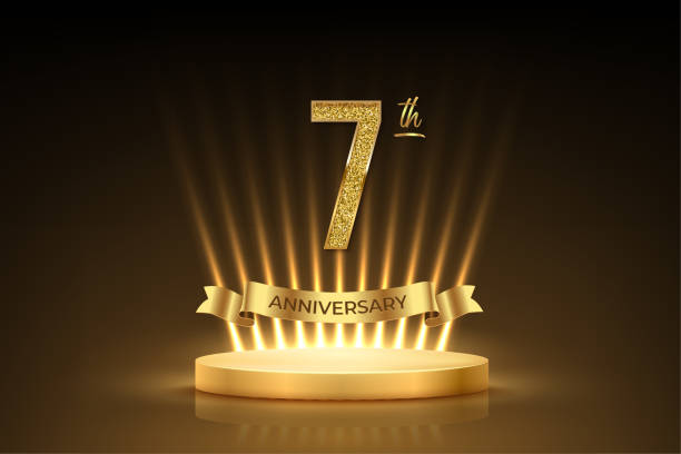 istock Seventh anniversary gold award podium. 7 year celebration birthday or jubilee golden vector background. Luxury stage with glowing rays, glittering number 7 and ribbon with text anniversary on black 2174278779