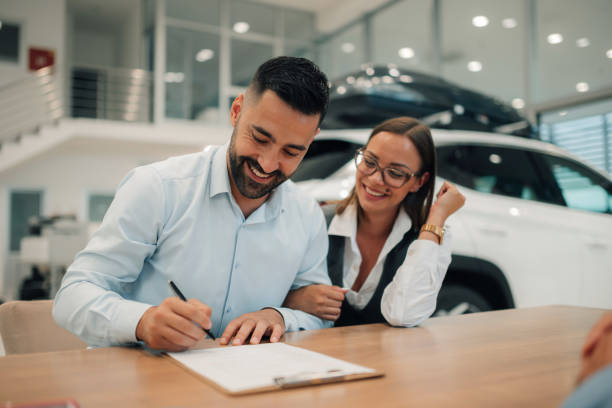 istock Couple completes car purchase, smiling at newfound freedom. 2174279101