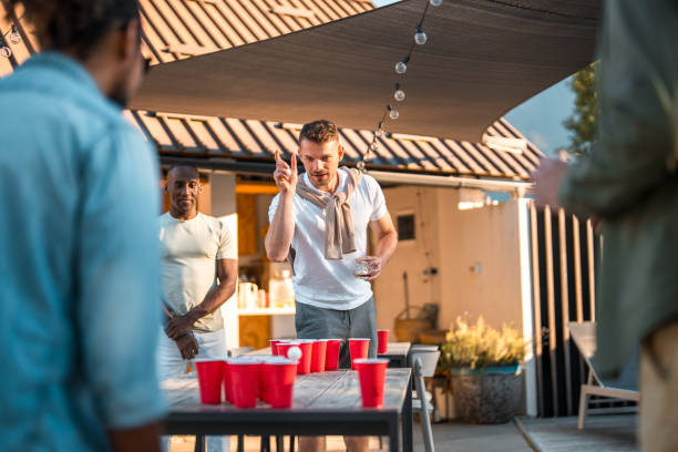 istock Diverse Friends Laughing and Competing in Beer Pong 2174281096