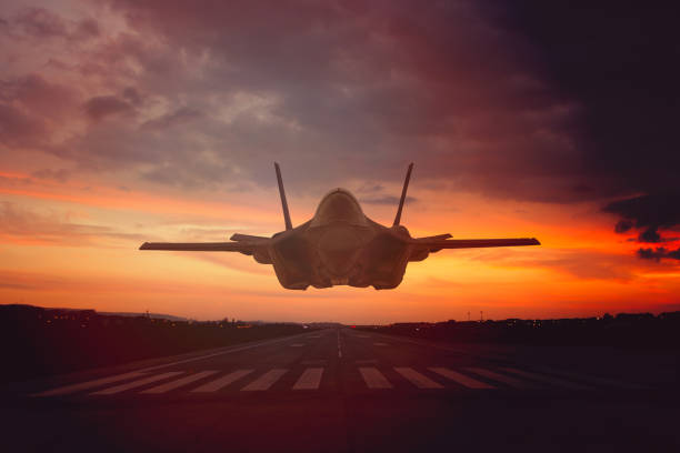 istock F 35 fighter plane is landing on sunset 2174281437