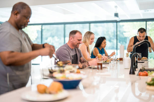 istock Diverse Group Sharing Meal in Rehab Facility 2174282830