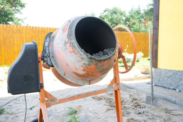 istock Mixing mortar in a handheld portable concrete mixer 2174287483