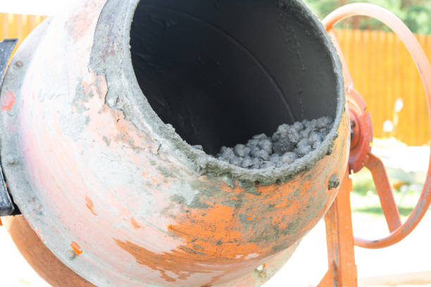 istock Mixing mortar in a handheld portable concrete mixer 2174287484