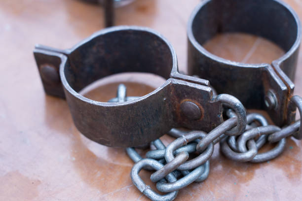 istock Ancient iron shackles of a slave with a chain 2174288531