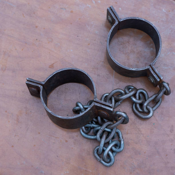 istock Ancient iron shackles of a slave with a chain 2174288532