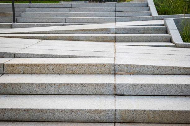 istock Tiled pedestrian pathway with steps within urban surroundings 2174290344