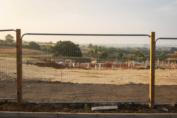 istock Fence around new build house development estate in england uk 2174290397