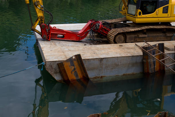 istock Excavator on a floating platform, cleaning and deepening the river 2174293813