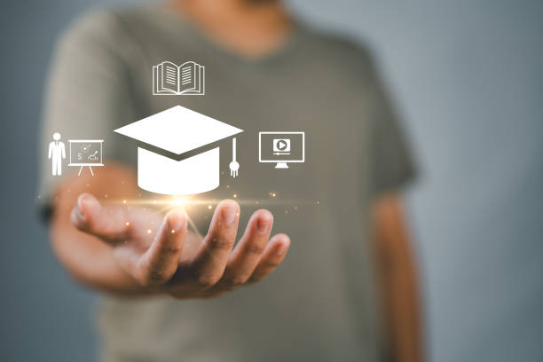 istock Online education. Businessman holding virtual online e-learning icons. Increase business working skills. Education internet technology. 2174294441