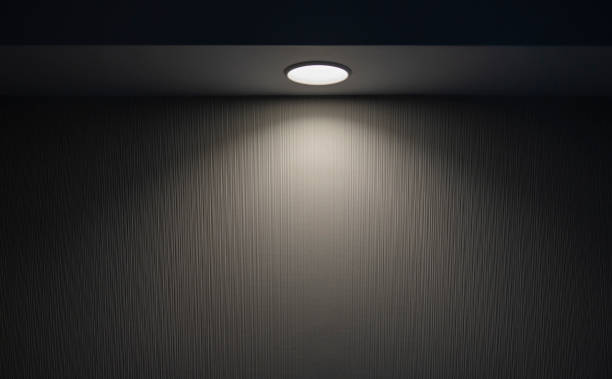 istock Ray of light from round compact lamp in dark room during night time 2174294609