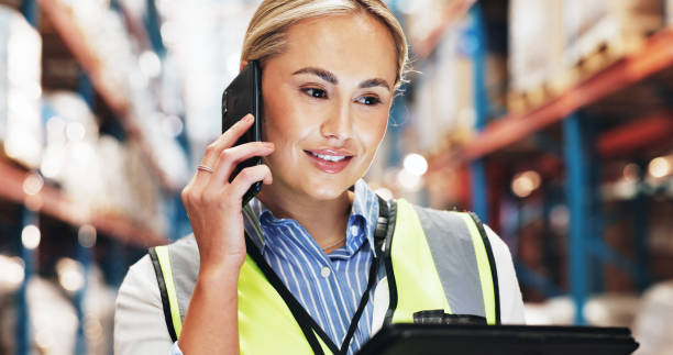 istock Logistics, woman and tablet with phone call for distribution, coordinate shipment and confirm delivery. Supply chain, female supervisor and digital with tech for inventory check, track stock or smile 2174296595