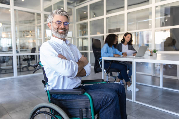 istock Disabled businessman with crossed arms working in modern office 2174298328